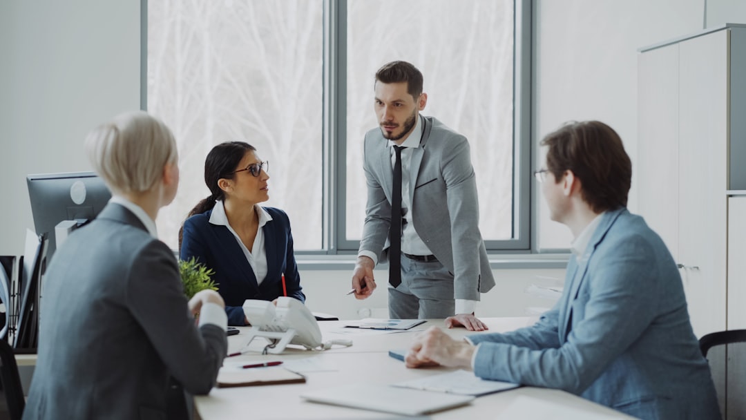 Professionals reviewing documents in a boardroom, representing commercial real estate due diligence